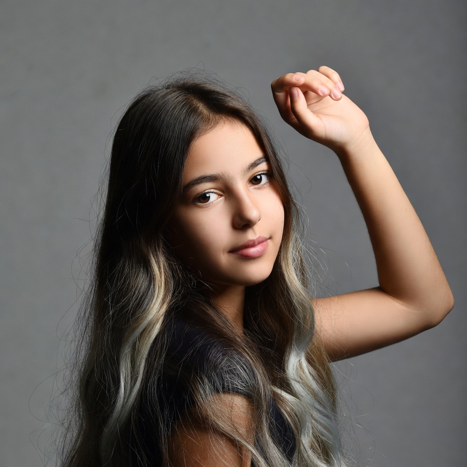 Teen girl flexing arm muscle Teen girl flexing arm muscle