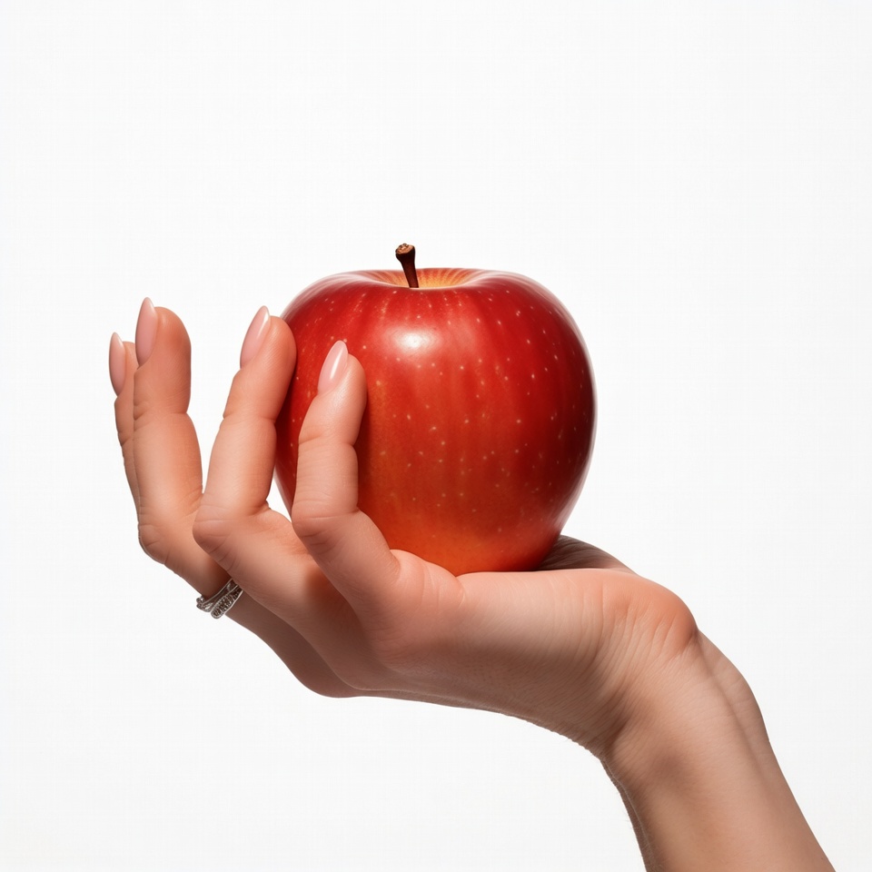 Woman's hand holding red apple Woman's hand holding red apple