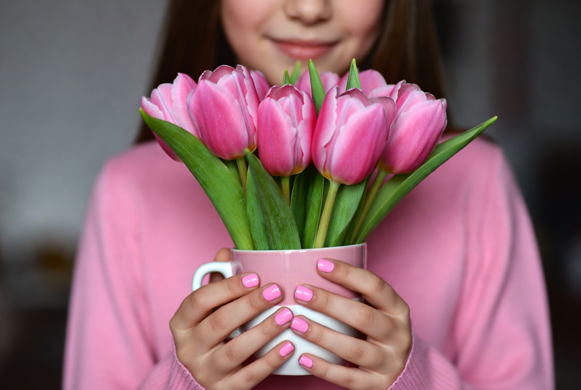 Girl holding pink tulips Girl holding pink tulips