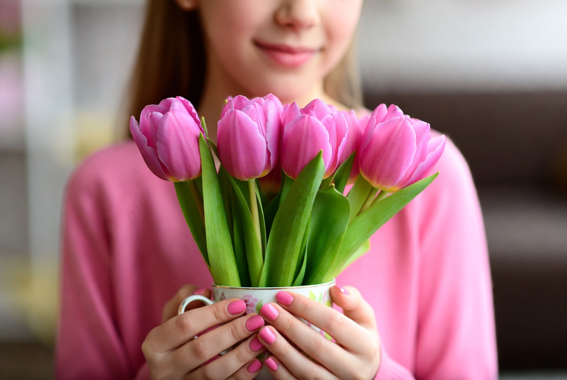 Girl holding pink tulips Girl holding pink tulips
