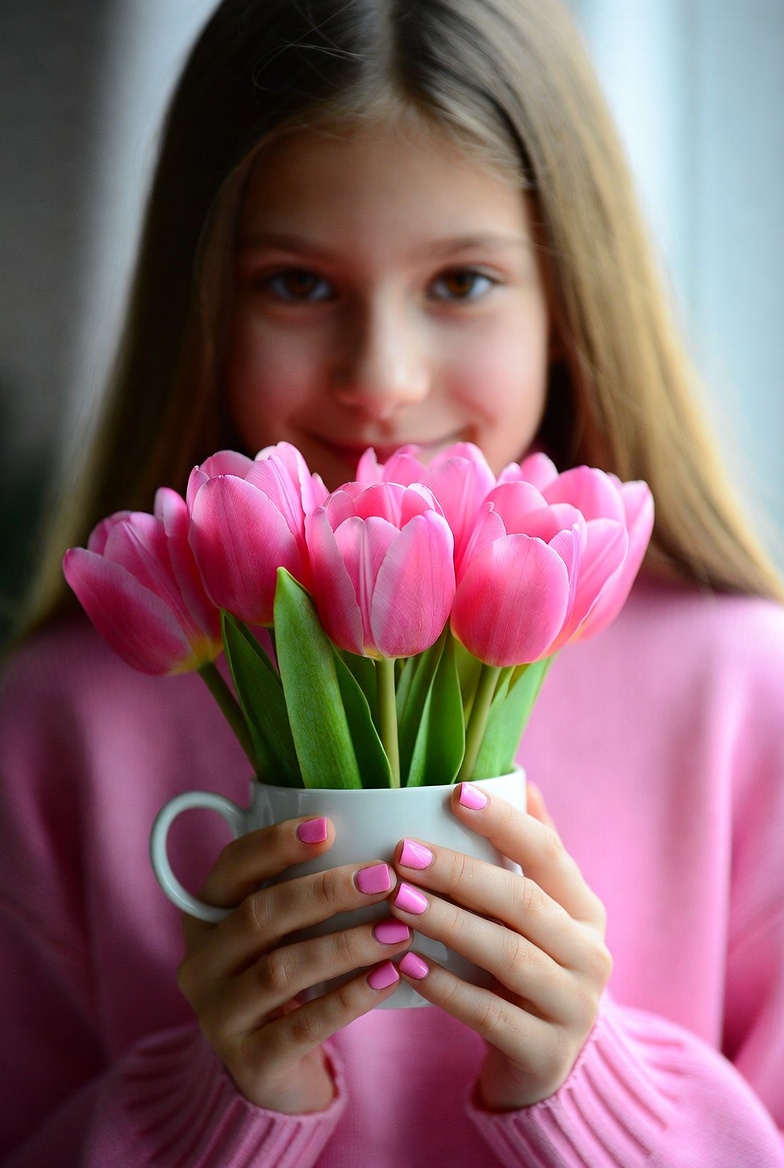 Girl holding pink tulips Girl holding pink tulips