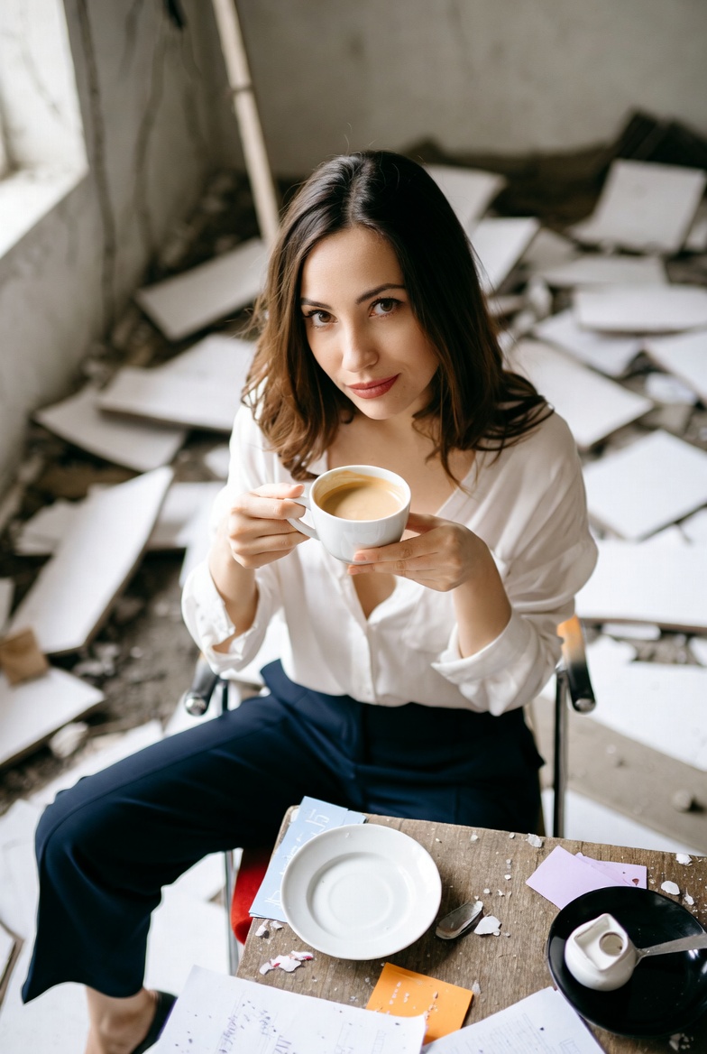 Woman drinking coffee in abandoned room Woman drinking coffee in abandoned room
