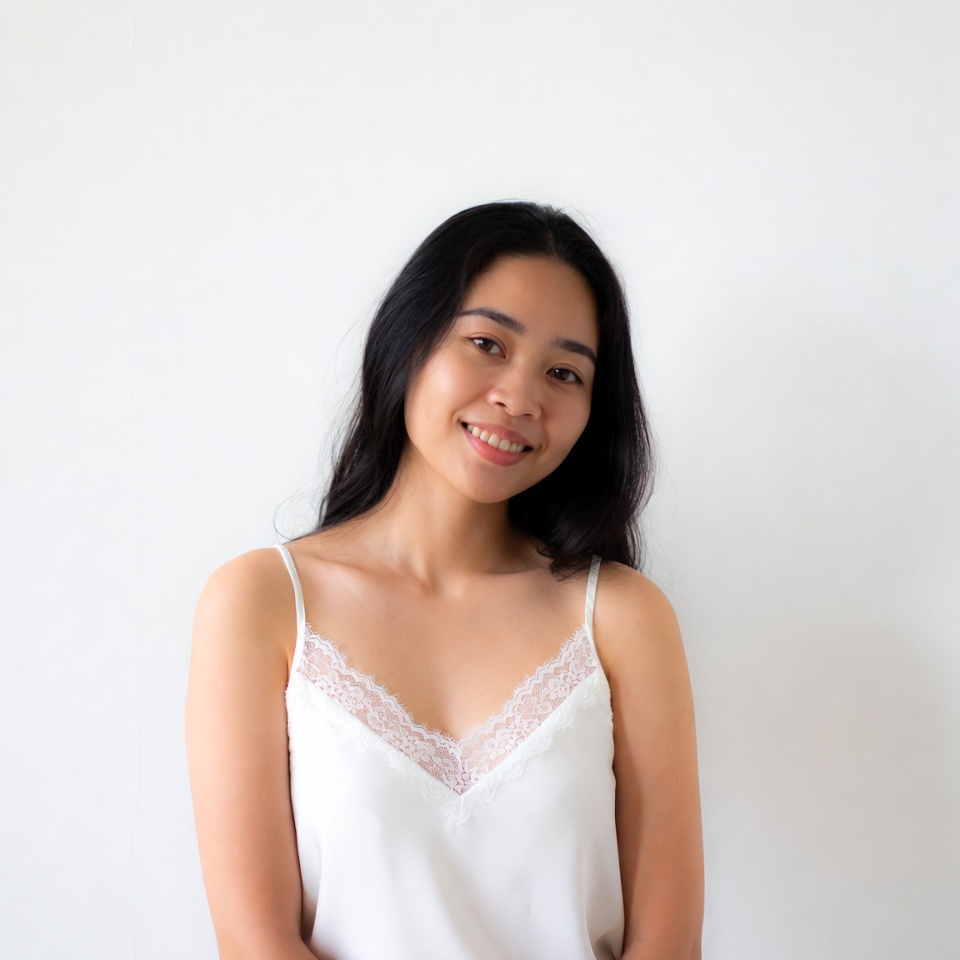 Asian woman smiling in lace camisole Asian woman smiling in lace camisole