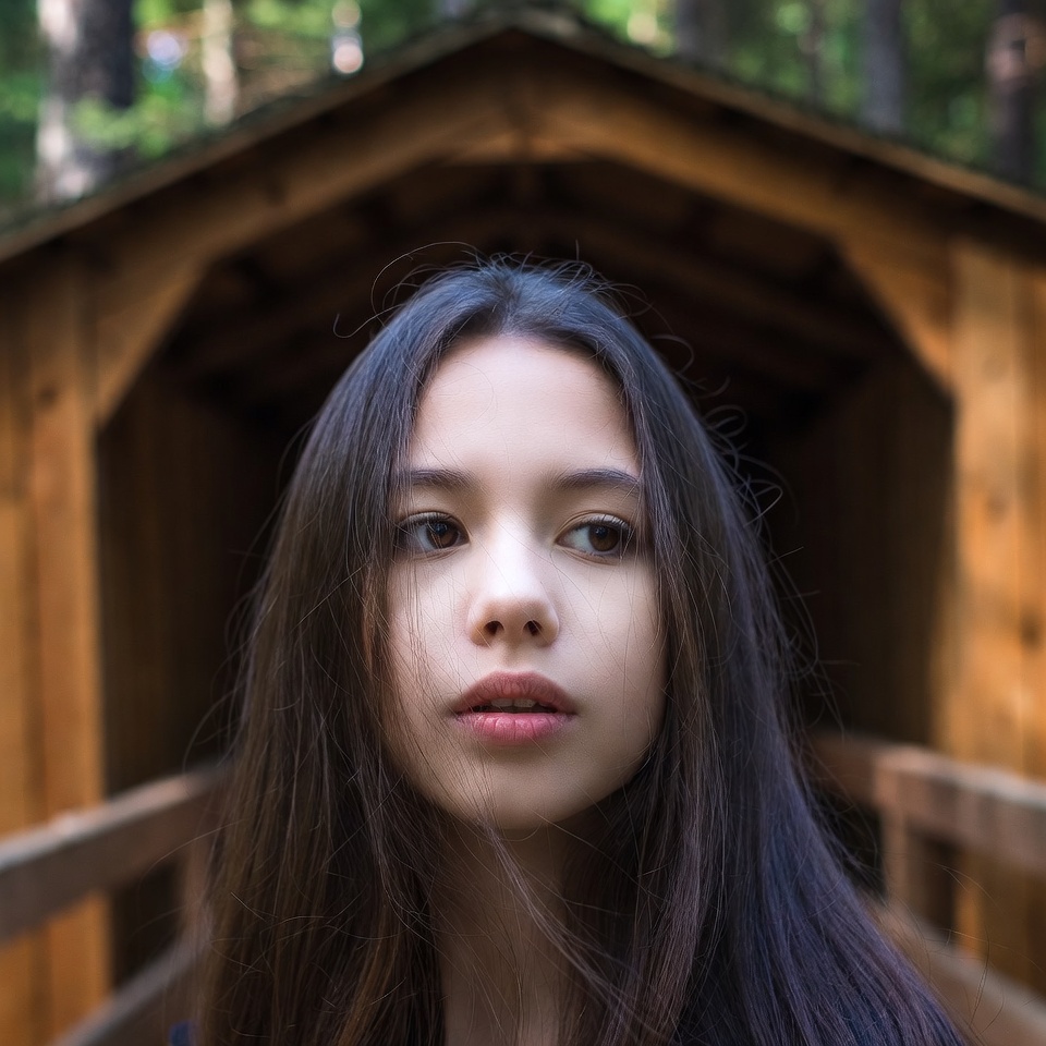 Young woman in wooden forest bridge Young woman in wooden forest bridge