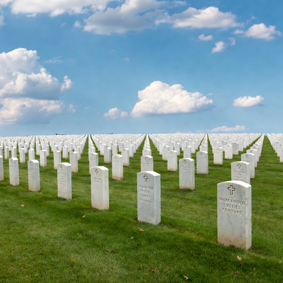 Rows of white gravestones in cemetery Rows of white gravestones in cemetery