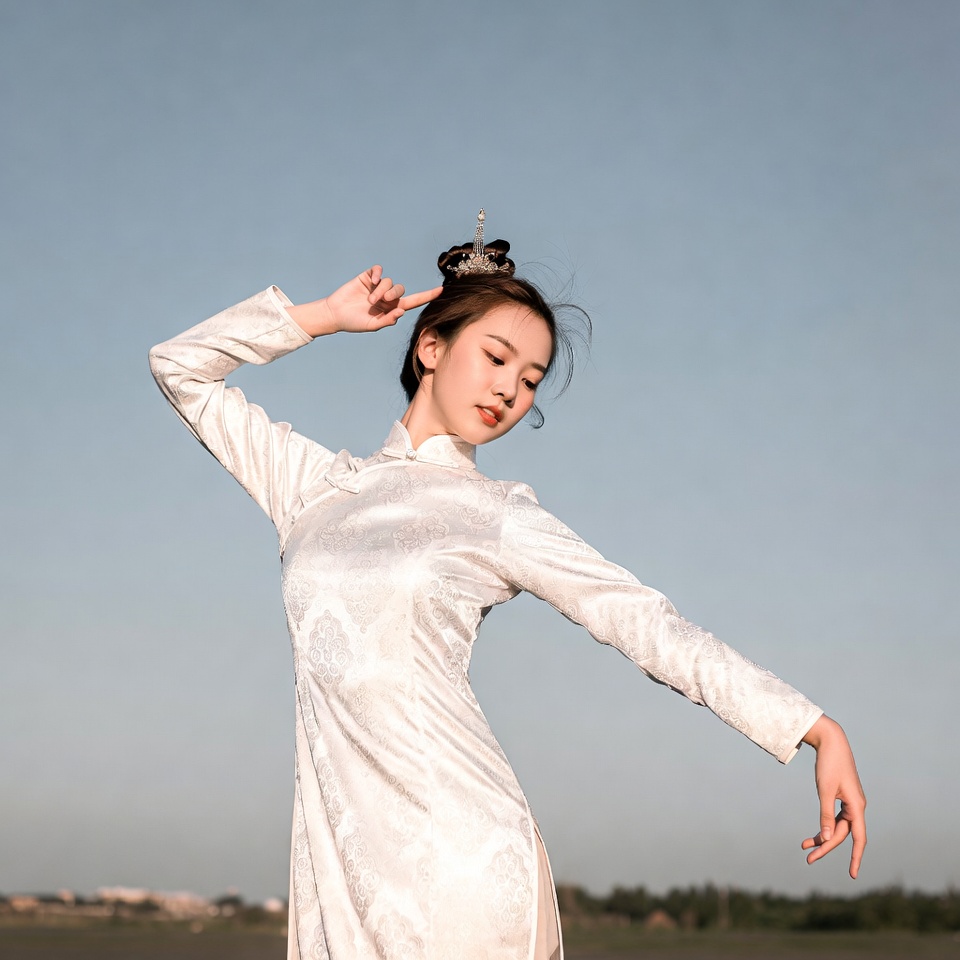 Asian woman in white qipao dancing Asian woman in white qipao dancing