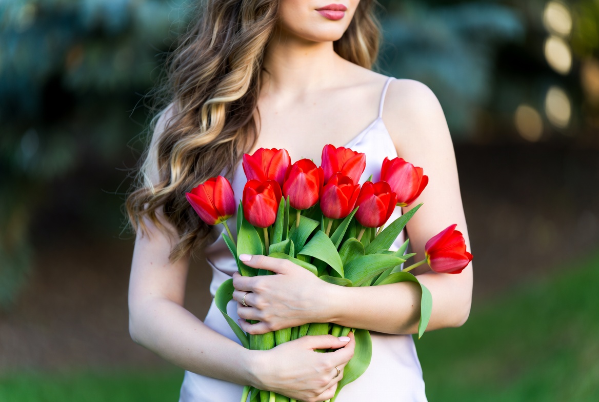 Woman holding red tulips Woman holding red tulips