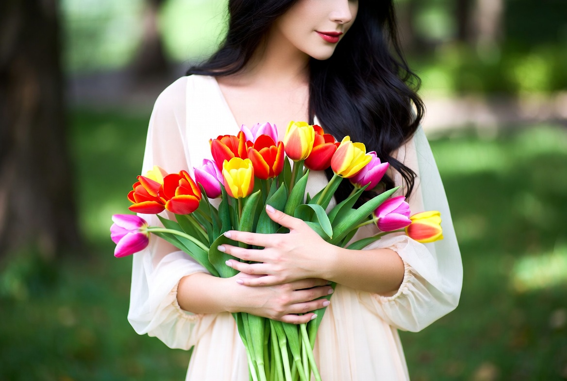 Asian woman holding colorful tulips Asian woman holding colorful tulips
