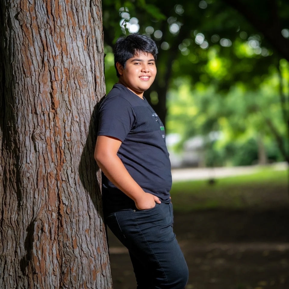 Boy leaning against tree Boy leaning against tree