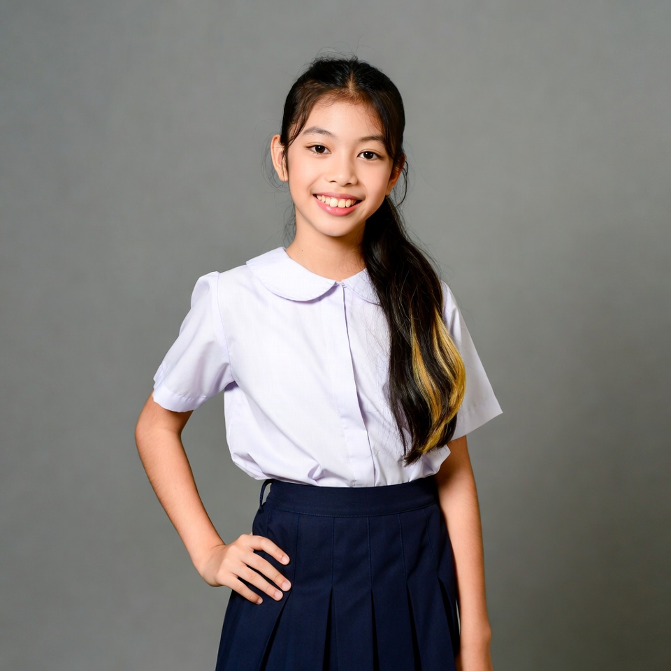 Asian girl in school uniform smiling Asian girl in school uniform smiling