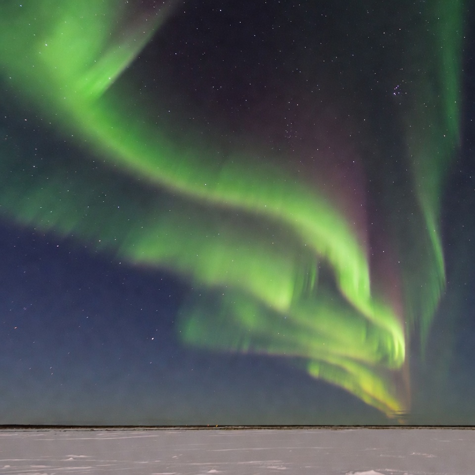 Vibrant Northern Lights over Snowy Landscape Vibrant Northern Lights over Snowy Landscape