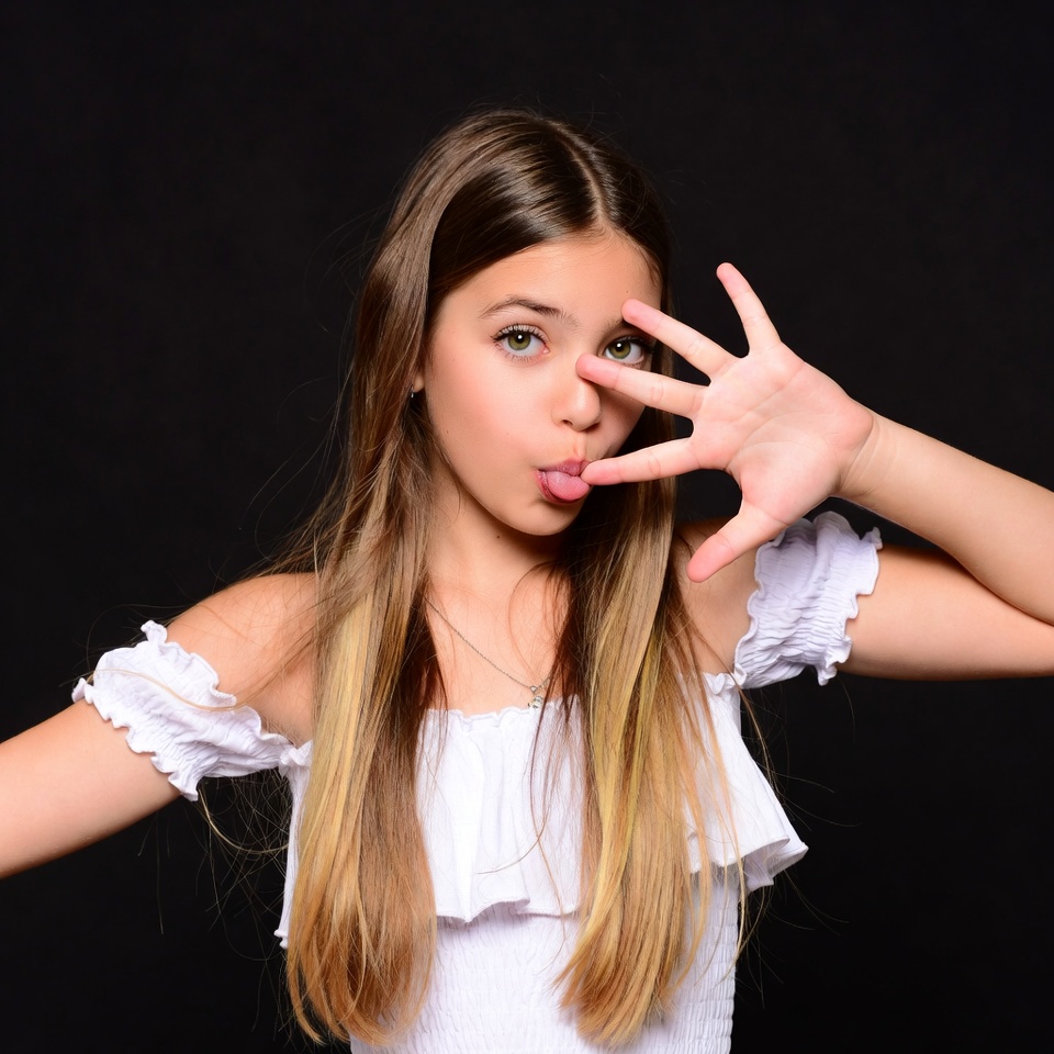 Girl making funny face with hand gesture Girl making funny face with hand gesture
