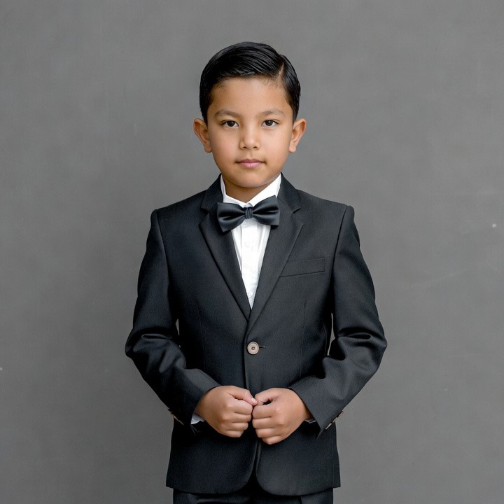 Young Asian boy in black tuxedo Young Asian boy in black tuxedo
