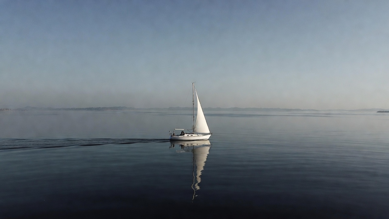White sailboat on calm water White sailboat on calm water