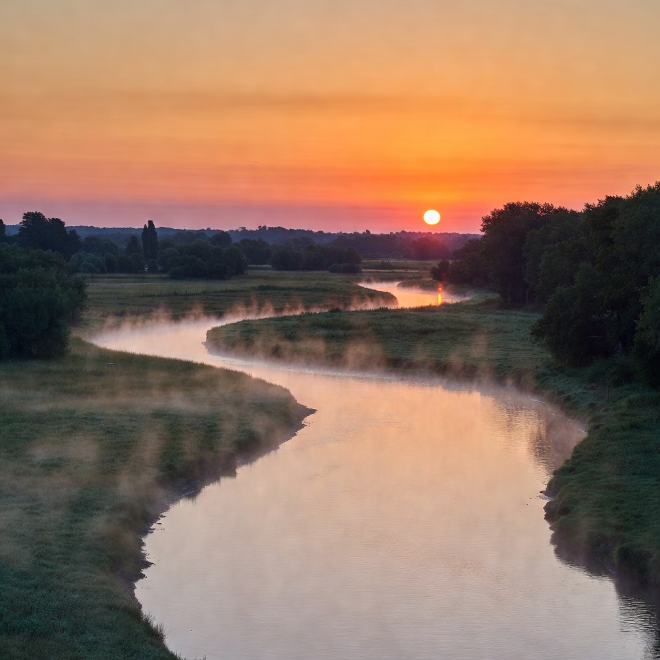 Sunset over winding river with mist Sunset over winding river with mist