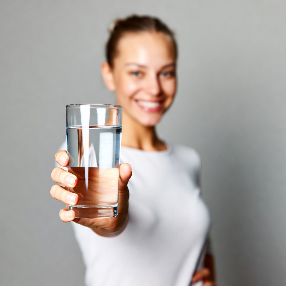 Woman holding glass of water Woman holding glass of water
