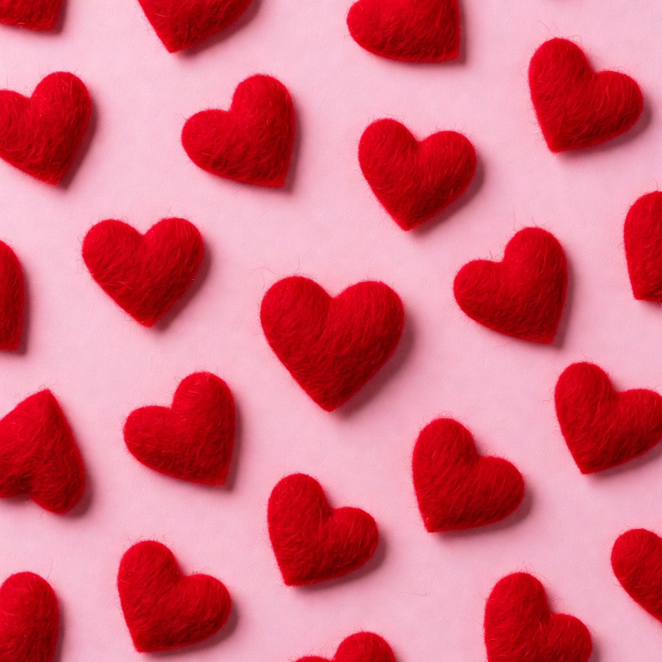 Red Felt Hearts on Pink Background Red Felt Hearts on Pink Background