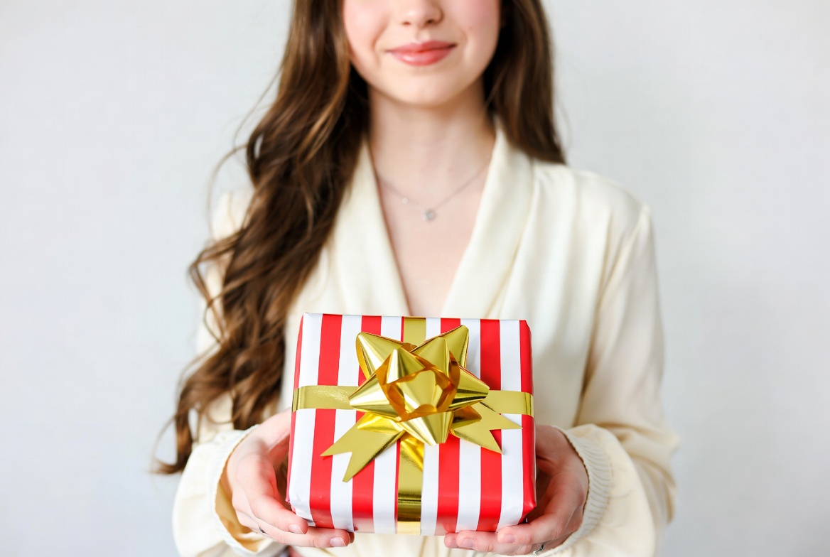 Young woman holding red gift box Young woman holding red gift box