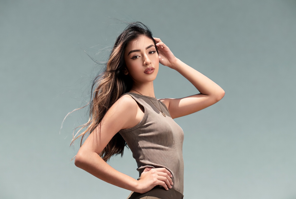 Asian woman hand on head posing Asian woman hand on head posing