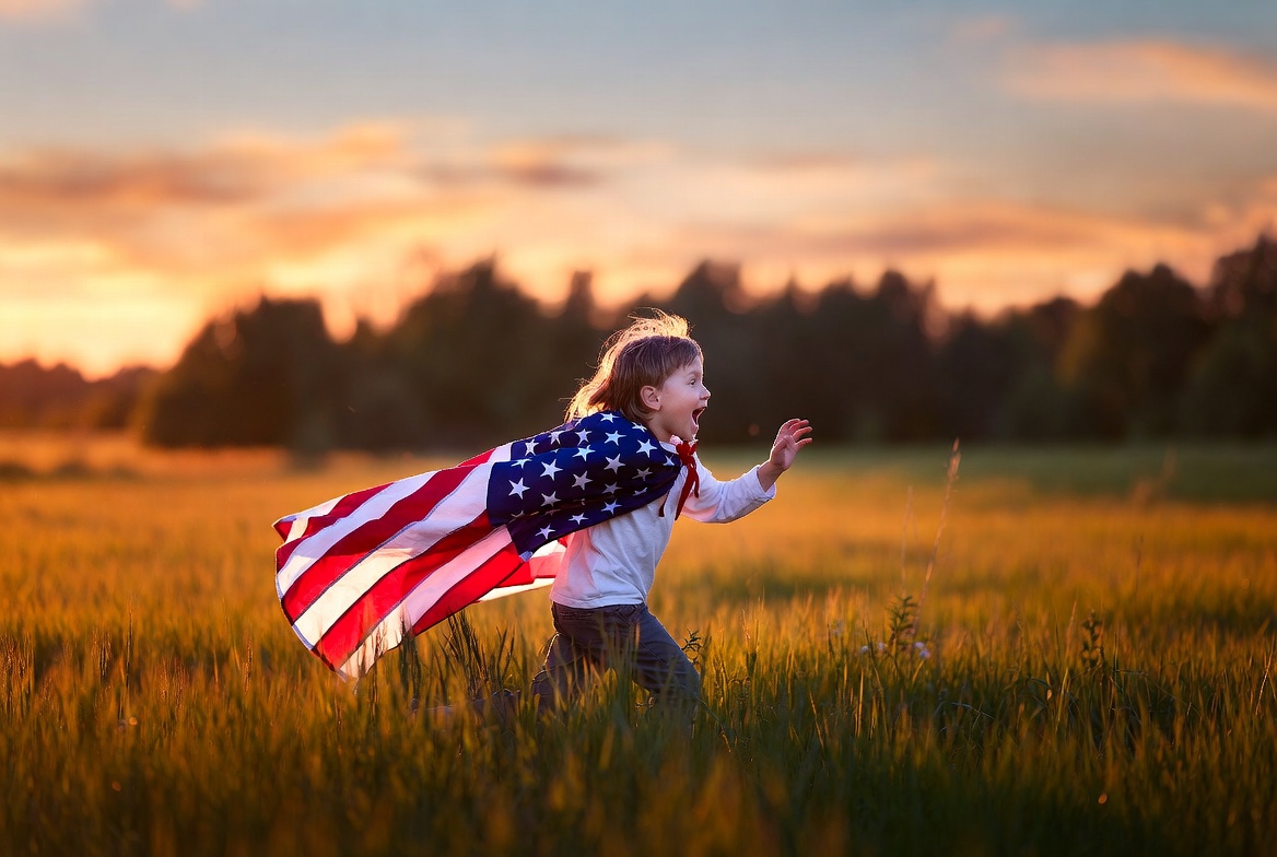 Girl running with American flag cape Girl running with American flag cape