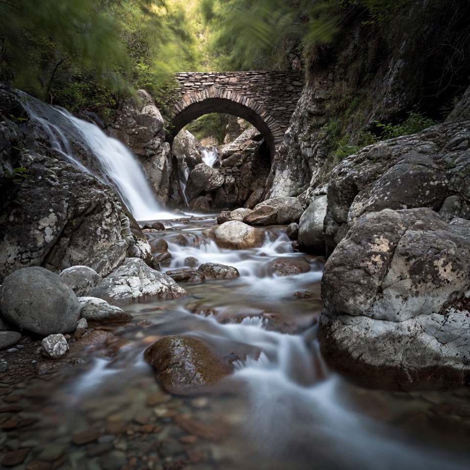 Stone Arch Bridge over Waterfall Stream Stone Arch Bridge over Waterfall Stream