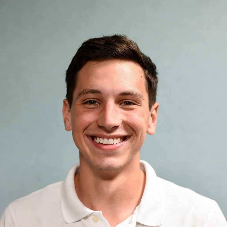 Smiling young man in white polo shirt Smiling young man in white polo shirt