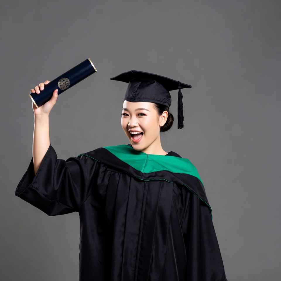 Asian woman holding graduation diploma Asian woman holding graduation diploma