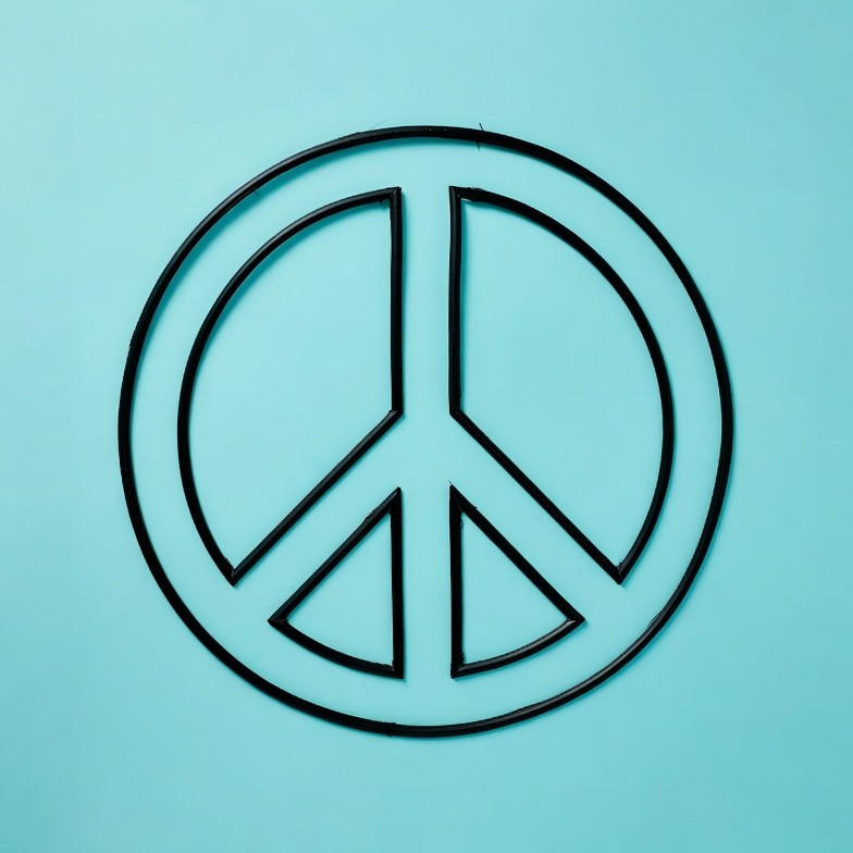 Black Peace Symbol on Blue Background Black Peace Symbol on Blue Background