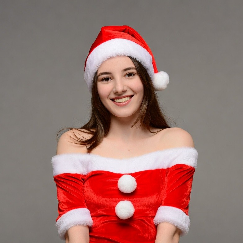 Smiling woman in Santa hat and dress Smiling woman in Santa hat and dress