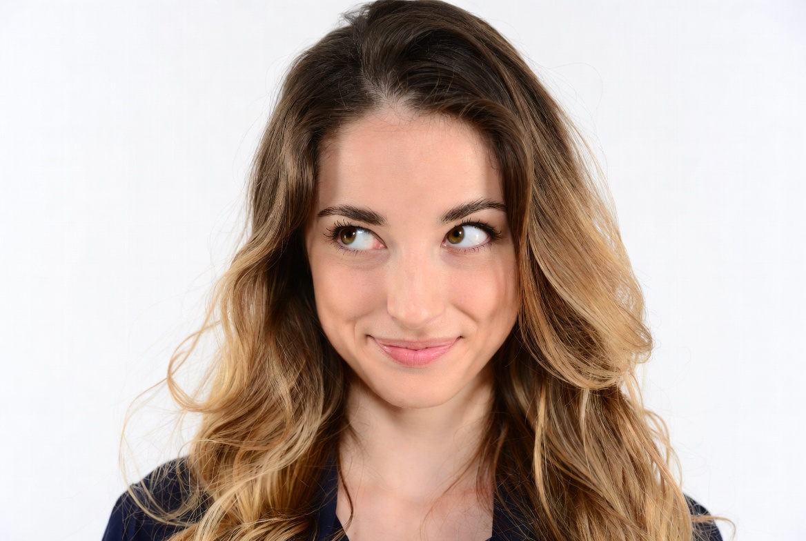 Woman smirking with playful side-eye Woman smirking with playful side-eye