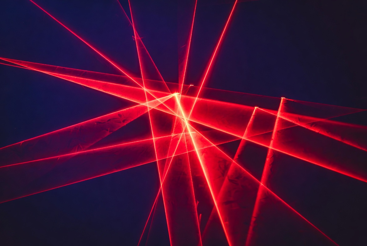 Red laser beams on dark background Red laser beams on dark background