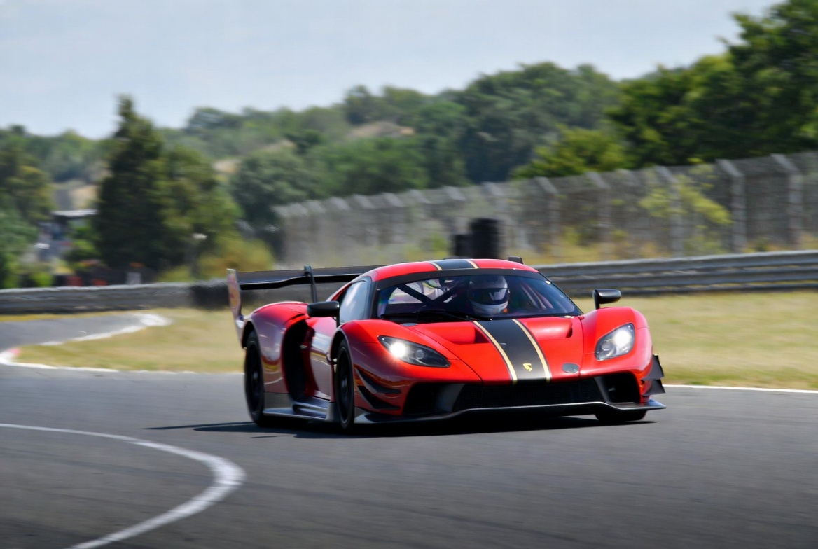 Red Race Car Cornering on Track Red Race Car Cornering on Track