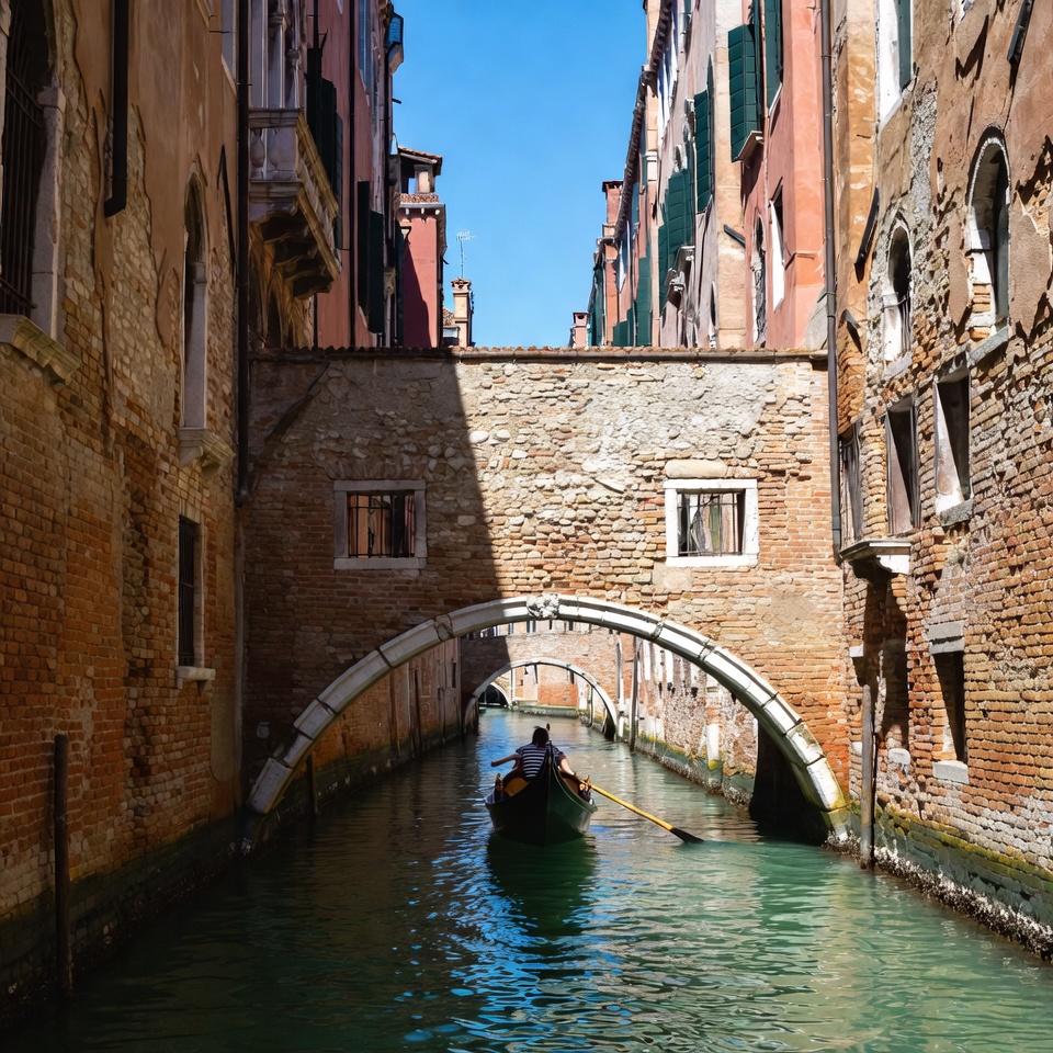 Gondolier rowing boat in Venice canal Gondolier rowing boat in Venice canal