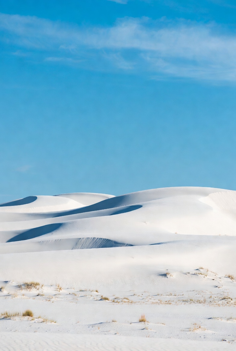 White sand dunes under blue sky White sand dunes under blue sky