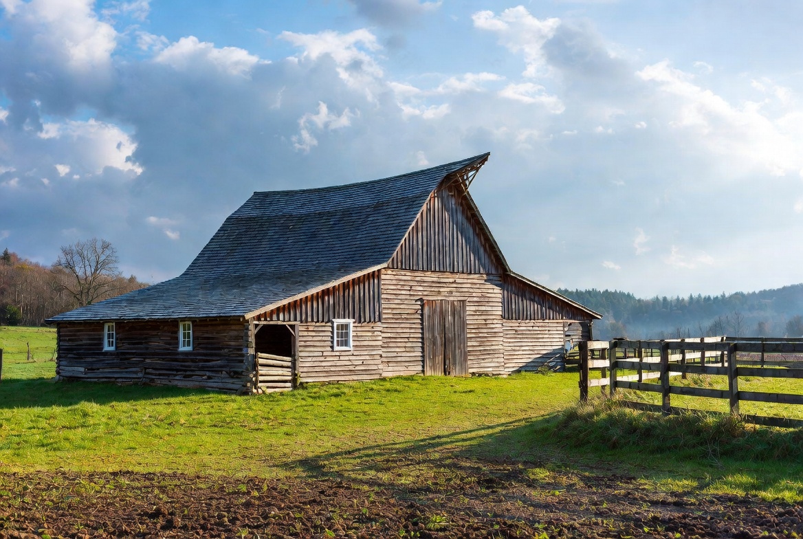 Old wooden barn in green field Old wooden barn in green field