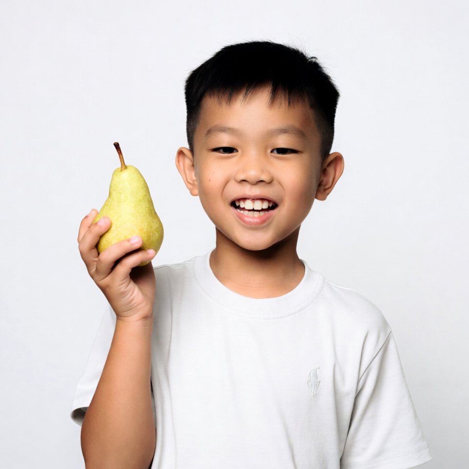 Asian boy holding green pear Asian boy holding green pear