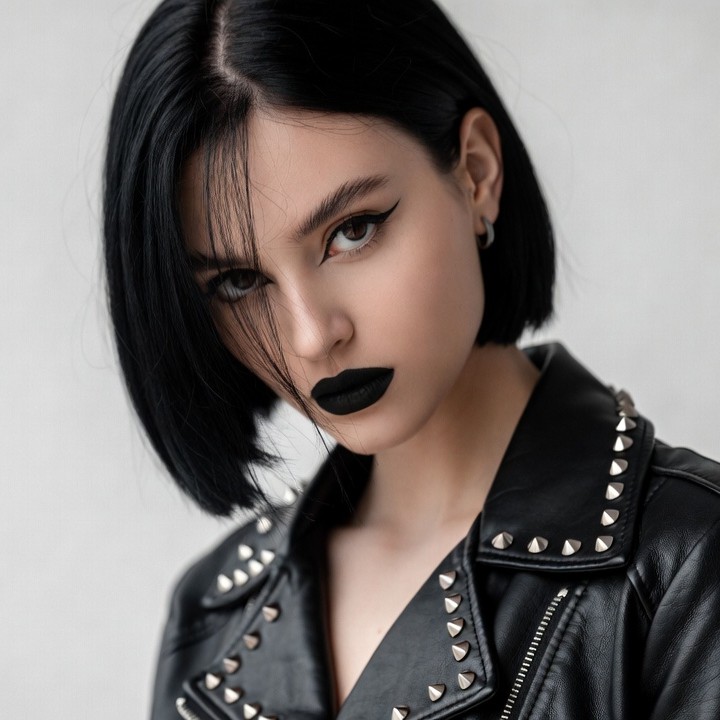 Woman with bob haircut in studded leather jacket Woman with bob haircut in studded leather jacket