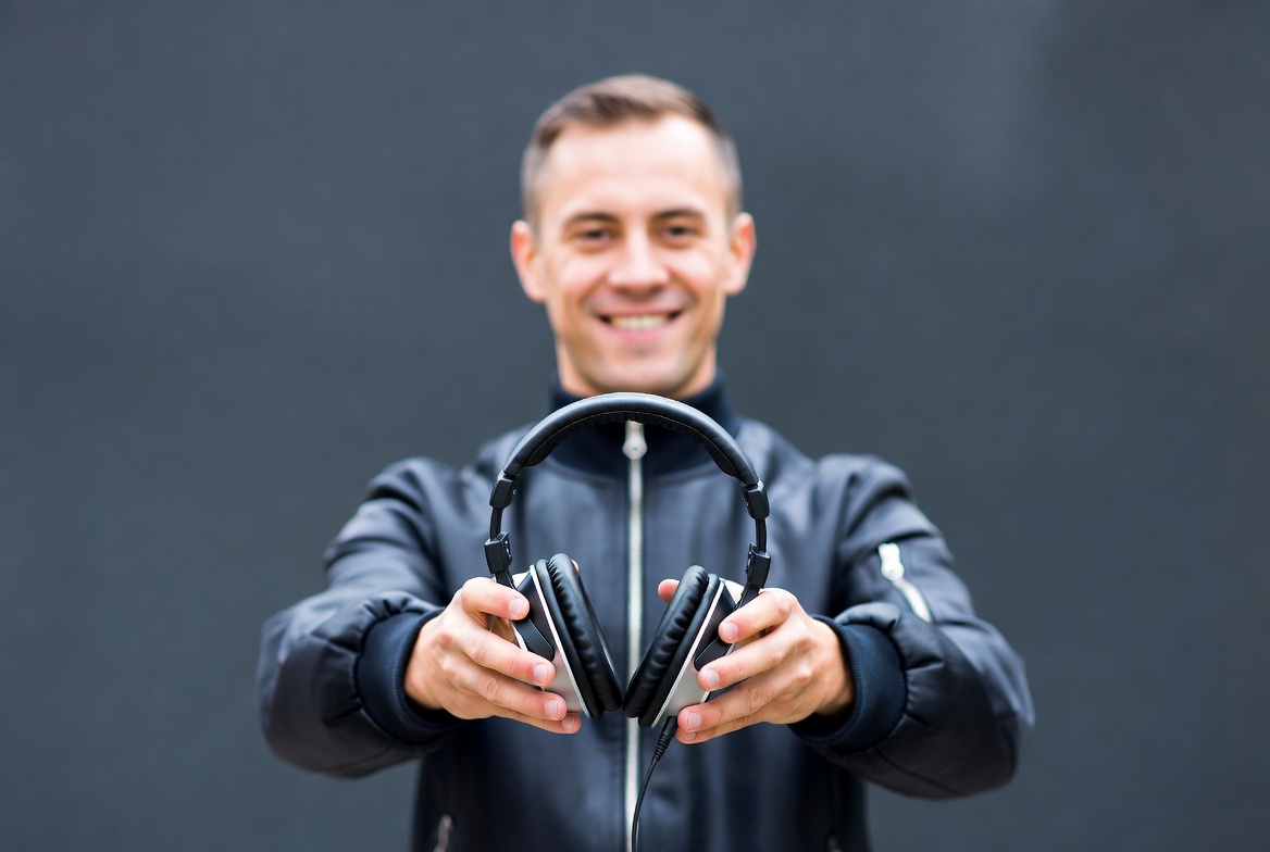 Man holding black headphones Man holding black headphones