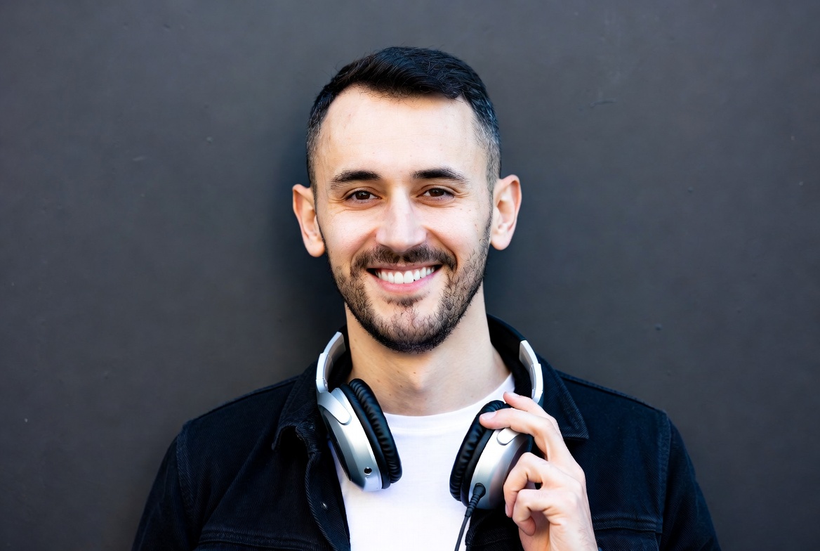 Man holding headphones Man holding headphones