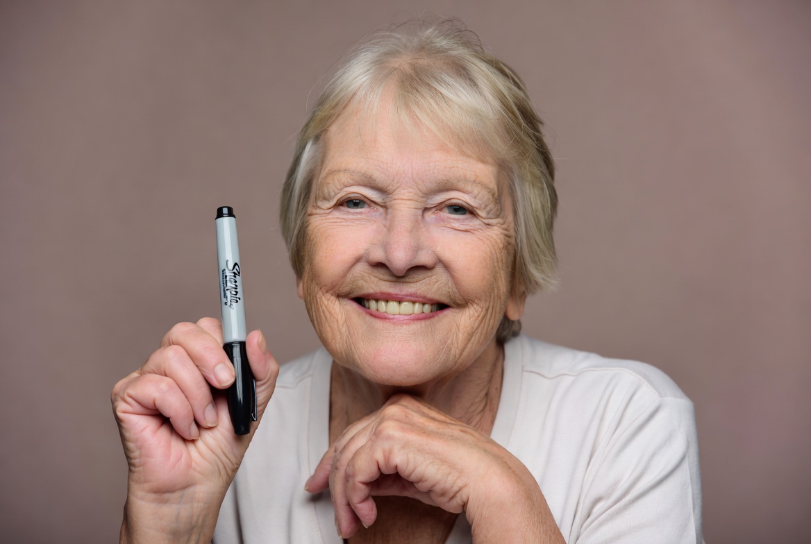 Elderly woman holding marker Elderly woman holding marker