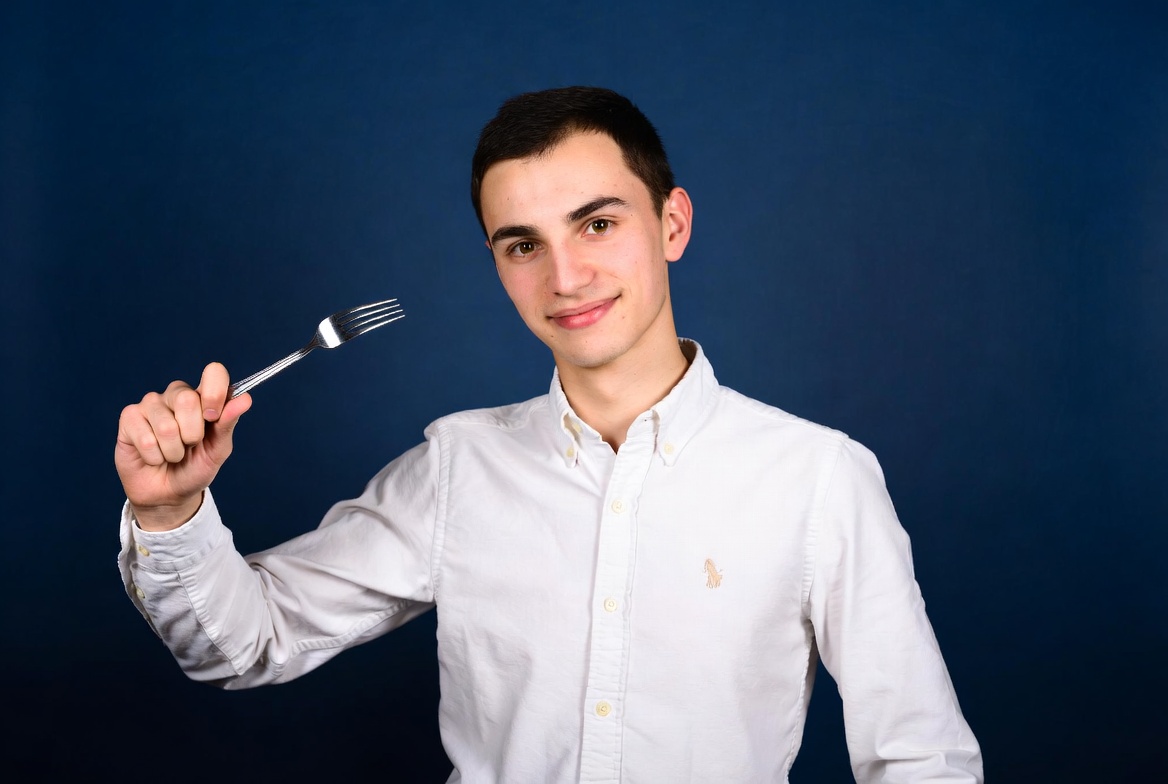 Young man holding fork Young man holding fork