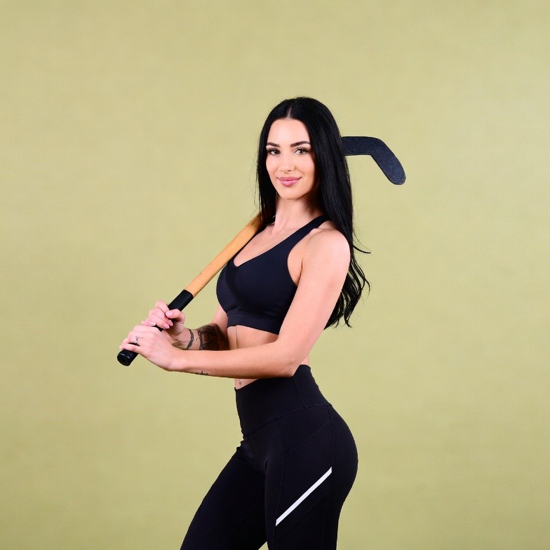 Woman holding hockey stick Woman holding hockey stick