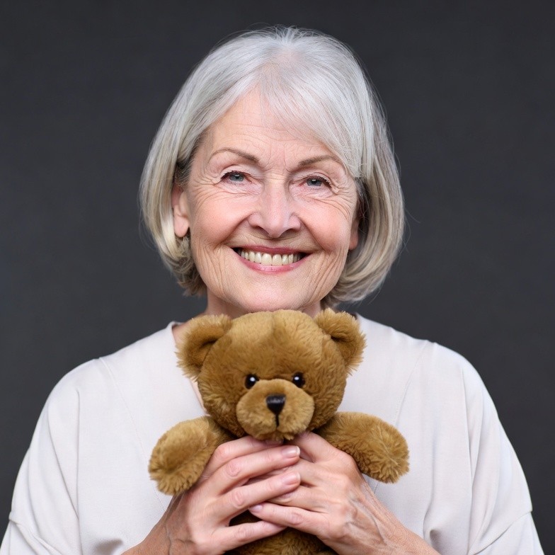 Elderly woman holding teddy bear Elderly woman holding teddy bear
