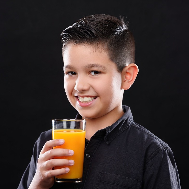 Boy holding glass of orange juice Boy holding glass of orange juice