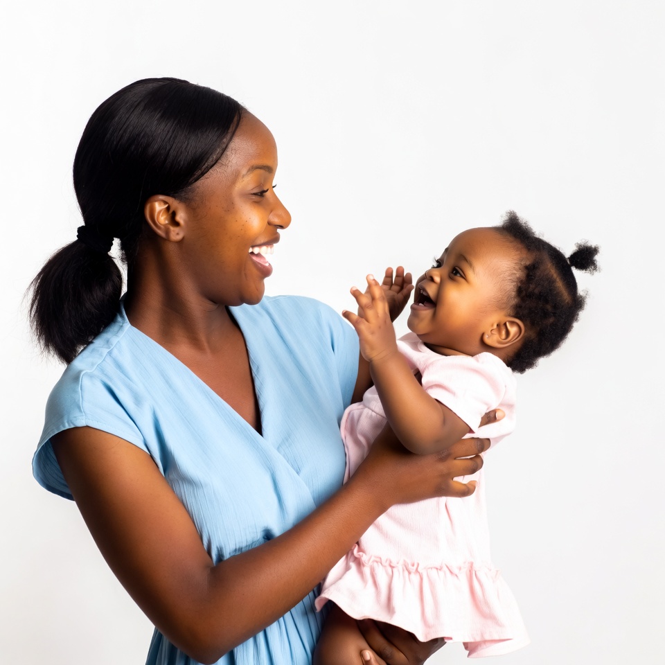 African-American mother holding laughing baby African-American mother holding laughing baby