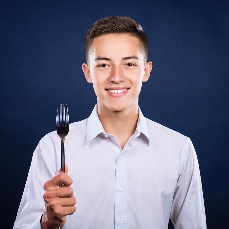 Young man holding fork Young man holding fork