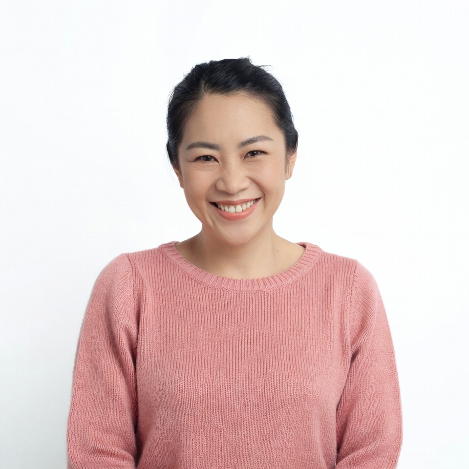 Smiling Asian woman in pink sweater Smiling Asian woman in pink sweater