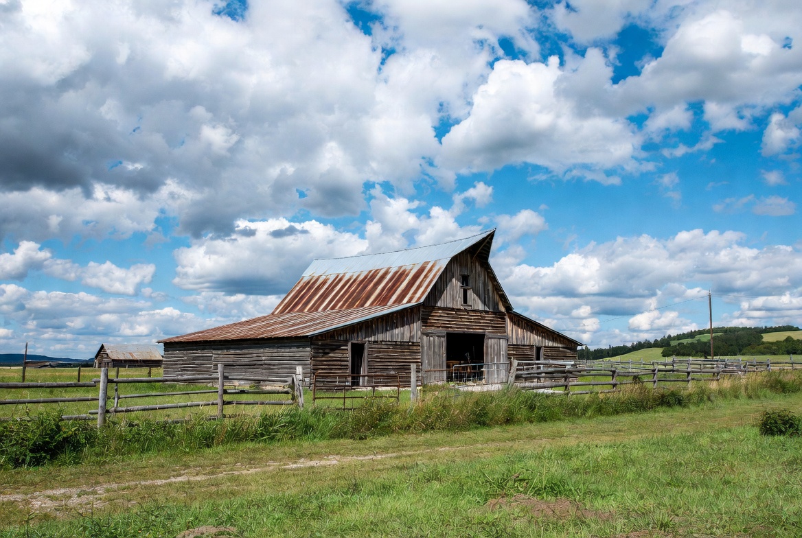 Rustic red barn in green field Rustic red barn in green field