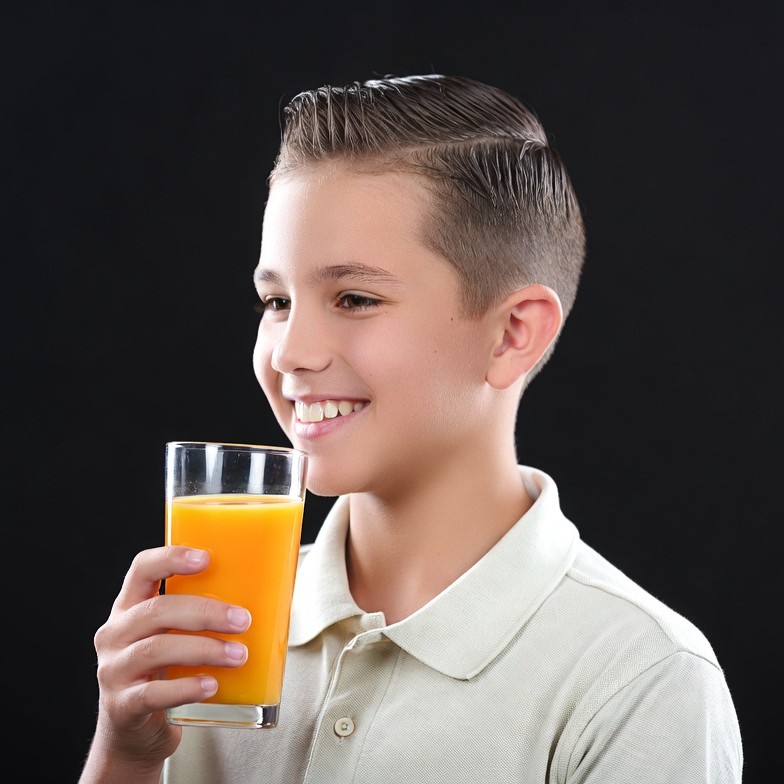 Boy drinking orange juice Boy drinking orange juice