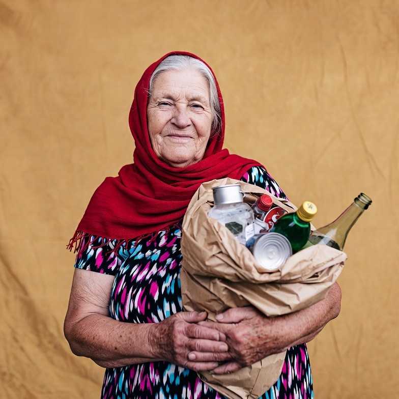 Elderly woman holding recycling bag Elderly woman holding recycling bag